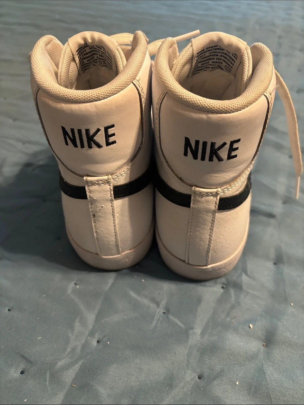 Nike White High-Top Sneakers with Black Swoosh